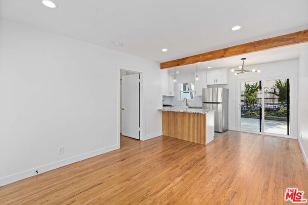 Empty room, Interior, Kitchen, Pendant Lights, Recessed Lighting, Stainless Steel Appliances, Wooden Beams, Wood Texture Flooring
