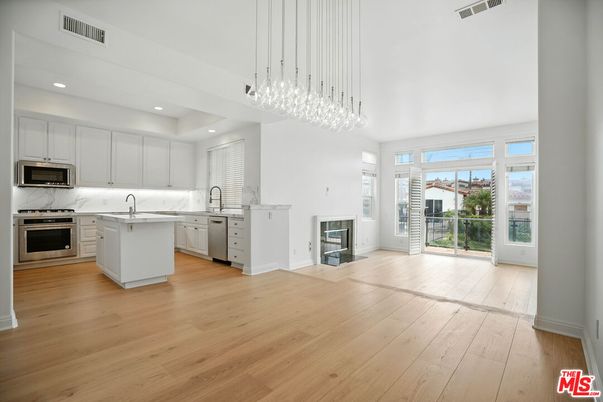 Fireplace, Interior, Kitchen, Marble Walls, Pendant Lights, Recessed Lighting, Stainless Steel Appliances, Wood Texture Flooring