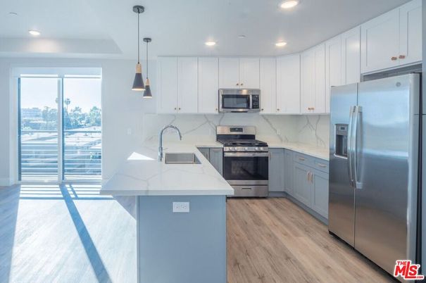 Interior, Kitchen, Marble Walls, Pendant Lights, Recessed Lighting, Stainless Steel Appliances, Wood Texture Flooring