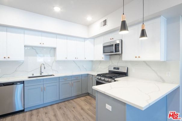Interior, Kitchen, Marble Walls, Pendant Lights, Recessed Lighting, Stainless Steel Appliances, Wood Texture Flooring