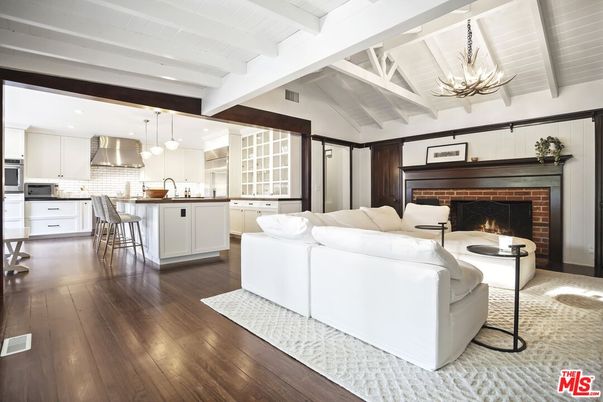 Chandelier, Fireplace, Interior, Kitchen, Living room, Pendant Lights, Recessed Lighting, Stainless Steel Appliances, Wood Texture Flooring