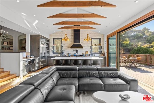 Chandelier, Interior, Kitchen, Living room, Recessed Lighting, Stainless Steel Appliances, Stone Walls, Wooden Beams, Wood Texture Flooring