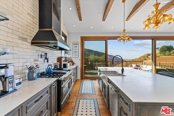 Chandelier, Interior, Kitchen, Pendant Lights, Recessed Lighting, Stainless Steel Appliances, Stone Walls, Wooden Beams, Wood Texture Flooring