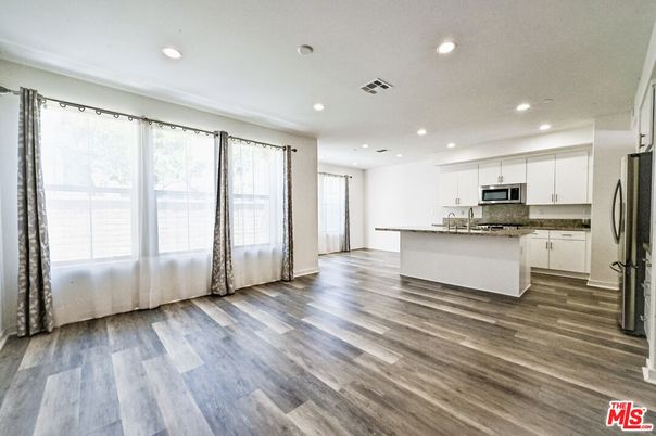 Empty room, Interior, Kitchen, Recessed Lighting, Stainless Steel Appliances, Wood Texture Flooring