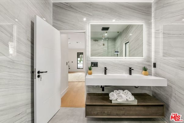 Bathroom, Dual Sink Vanities, Glass Shower, Interior, Marble Walls, Recessed Lighting, Wood Texture Flooring