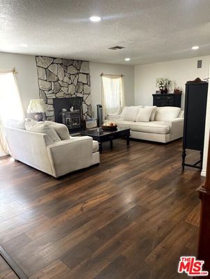 Fireplace, Interior, Living room, Recessed Lighting, Stone Walls, Wood Texture Flooring