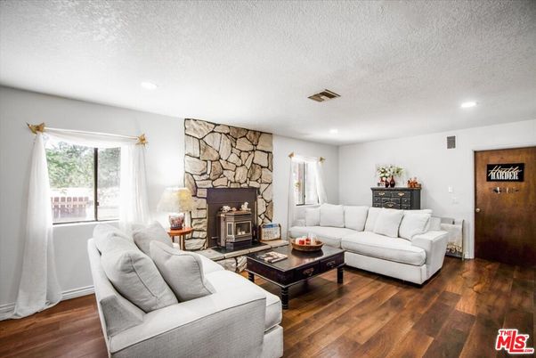 Fireplace, Interior, Living room, Recessed Lighting, Stone Walls, Wood Texture Flooring