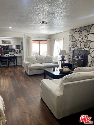 Dining room, Fireplace, Interior, Living room, Recessed Lighting, Stone Walls, Wood Texture Flooring