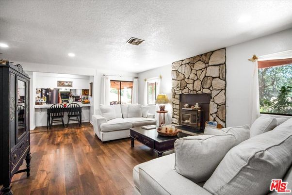 Dining room, Fireplace, Interior, Living room, Recessed Lighting, Stone Walls, Wood Texture Flooring