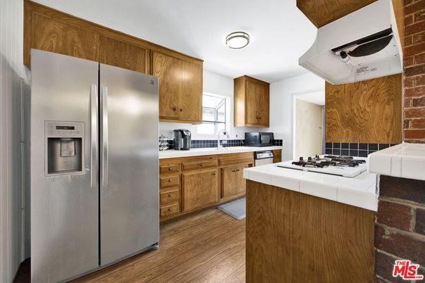 Interior, Kitchen, Stainless Steel Appliances, Tile Countertops, Wood Texture Flooring