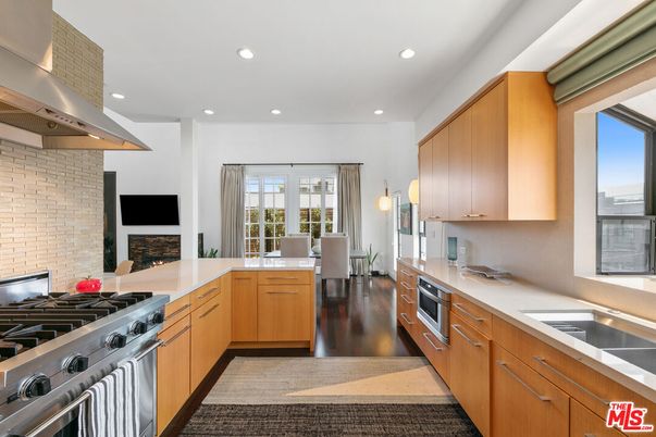 Dining room, Fireplace, Interior, Kitchen, Recessed Lighting, Stainless Steel Appliances, Stone Walls, Wood Texture Flooring