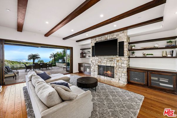 Fireplace, Interior, Living room, Recessed Lighting, Stone Walls, Water, Wooden Beams, Wood Texture Flooring