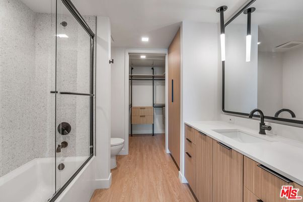 Bathroom, Dual Sink Vanities, Glass Shower, Interior, Recessed Lighting, Wood Texture Flooring