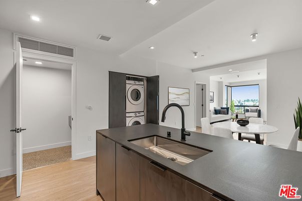 Interior, Kitchen, Recessed Lighting, Washer, Wood Texture Flooring