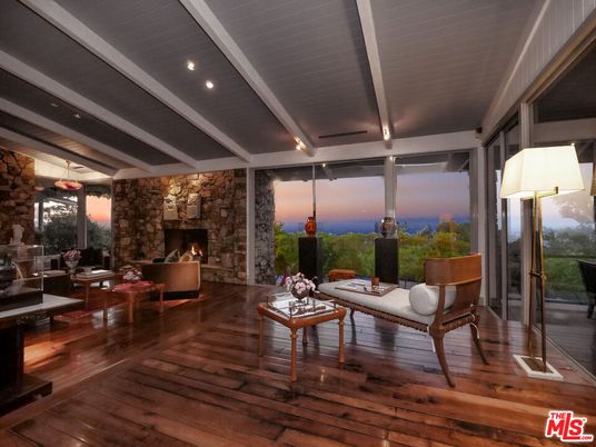 Fireplace, Interior, Living room, Recessed Lighting, Stone Walls, Water, Wood Texture Flooring