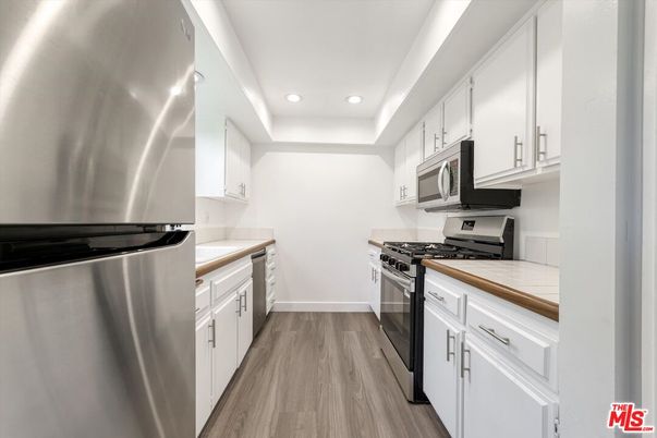 Interior, Kitchen, Recessed Lighting, Stainless Steel Appliances, Tile Countertops, Wood Texture Flooring