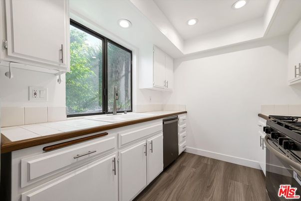 Interior, Kitchen, Recessed Lighting, Stainless Steel Appliances, Tile Countertops, Wood Texture Flooring