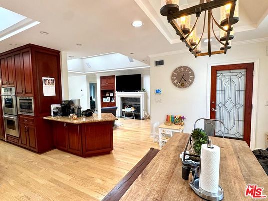 Chandelier, Dining room, Fireplace, Interior, Kitchen, Recessed Lighting, Stainless Steel Appliances, Wood Texture Flooring