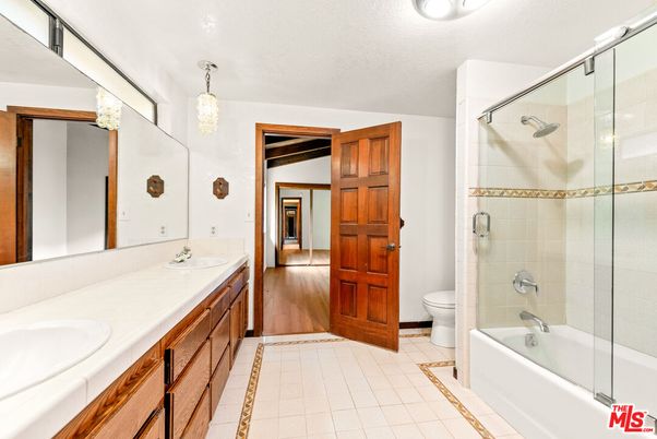 Bathroom, Dual Sink Vanities, Glass Shower, Interior, Pendant Lights, Tile Countertops, Wood Texture Flooring