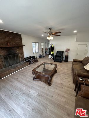 Fireplace, Interior, Living room, Recessed Lighting, Stone Walls, Wood Texture Flooring