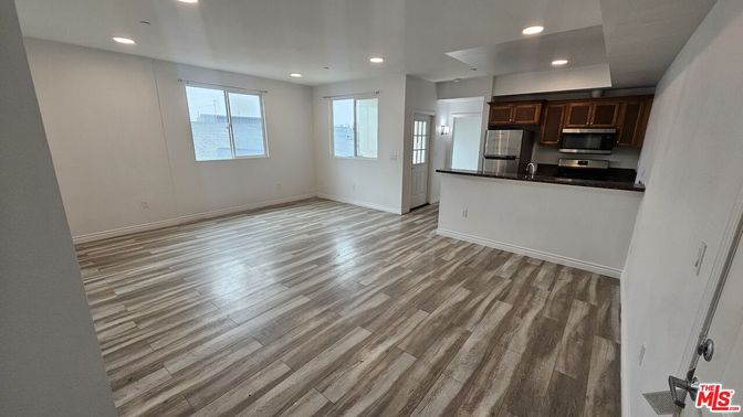 Empty room, Interior, Kitchen, Recessed Lighting, Stainless Steel Appliances, Wood Texture Flooring