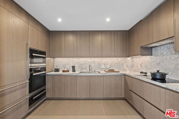 Interior, Kitchen, Marble Walls, Recessed Lighting, Stainless Steel Appliances, Wood Texture Flooring
