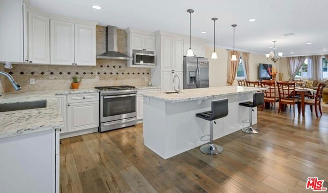 Chandelier, Dining room, Interior, Kitchen, Pendant Lights, Recessed Lighting, Stainless Steel Appliances, Wood Texture Flooring