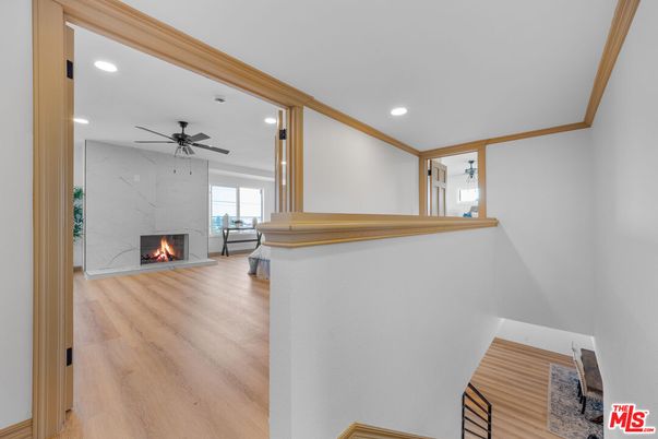 Fireplace, Interior, Marble Walls, Recessed Lighting, Wood Texture Flooring