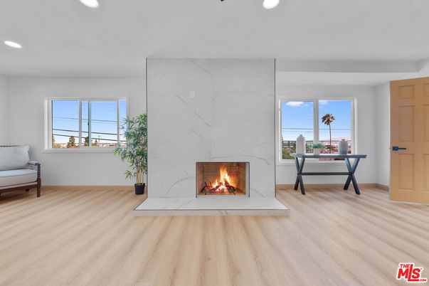 Fireplace, Interior, Marble Walls, Recessed Lighting, Wood Texture Flooring