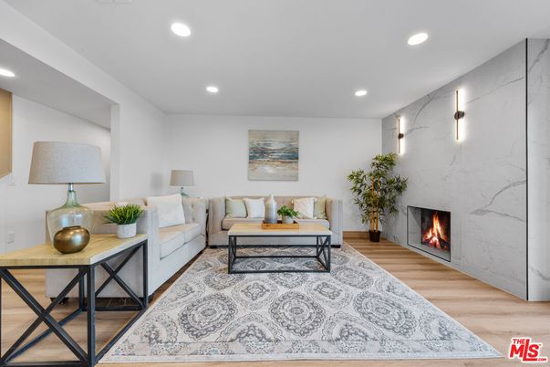 Fireplace, Interior, Living room, Marble Walls, Recessed Lighting, Wood Texture Flooring