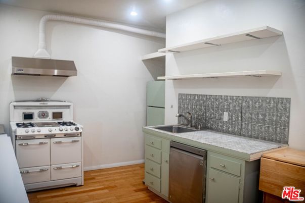 Interior, Kitchen, Recessed Lighting, Stainless Steel Appliances, Tile Countertops, Wood Texture Flooring