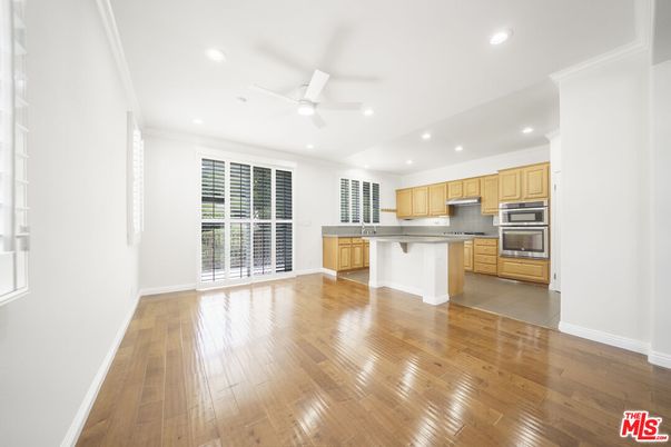 Empty room, Interior, Kitchen, Recessed Lighting, Stainless Steel Appliances, Wood Texture Flooring