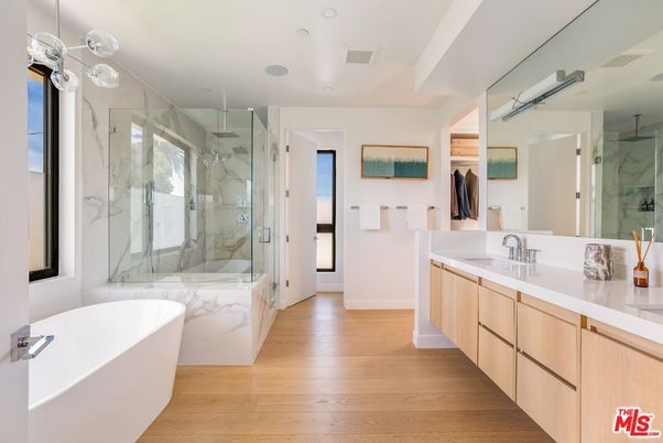 Bathroom, Dual Sink Vanities, Free Standing Baths, Glass Shower, Interior, Marble Walls, Recessed Lighting, Wood Texture Flooring