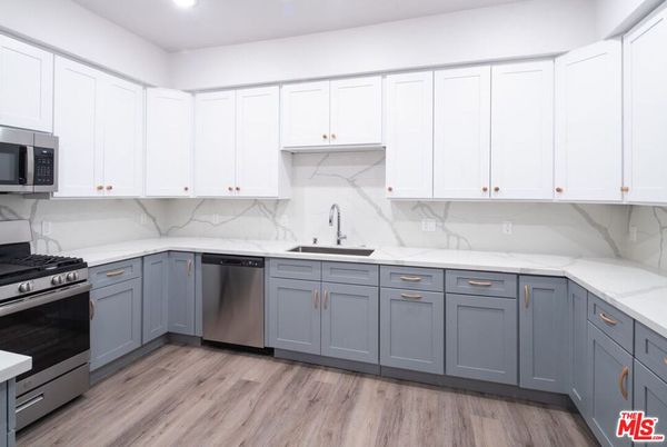 Interior, Kitchen, Marble Walls, Recessed Lighting, Stainless Steel Appliances, Wood Texture Flooring