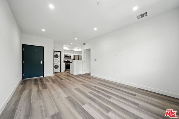 Empty room, Interior, Kitchen, Recessed Lighting, Stainless Steel Appliances, Wood Texture Flooring