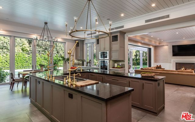 Chandelier, Dining room, Fireplace, Interior, Kitchen, Living room, Pendant Lights, Recessed Lighting, Stainless Steel Appliances