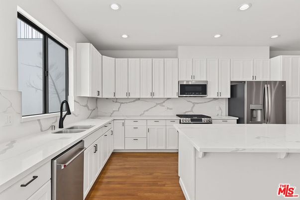 Interior, Kitchen, Marble Walls, Recessed Lighting, Stainless Steel Appliances, Wood Texture Flooring