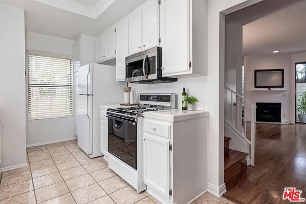 Fireplace, Interior, Kitchen, Recessed Lighting, Tile Countertops, Wood Texture Flooring
