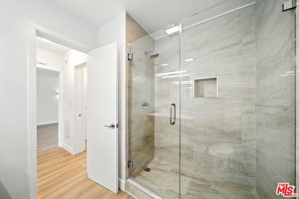 Bathroom, Glass Shower, Interior, Marble Walls, Recessed Lighting, Wood Texture Flooring
