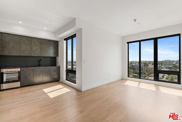 Empty room, Interior, Kitchen, Recessed Lighting, Stainless Steel Appliances, Wood Texture Flooring