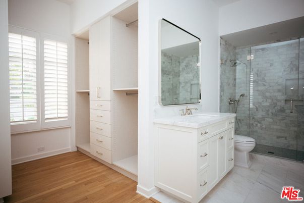 Bathroom, Dual Sink Vanities, Glass Shower, Interior, Marble Walls, Wood Texture Flooring