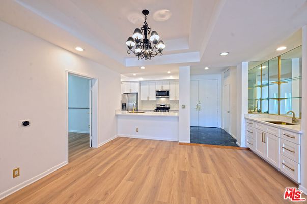 Chandelier, Empty room, Interior, Kitchen, Recessed Lighting, Stainless Steel Appliances, Wood Texture Flooring