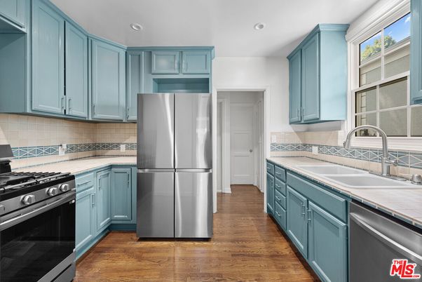 Interior, Kitchen, Recessed Lighting, Stainless Steel Appliances, Tile Countertops, Wood Texture Flooring