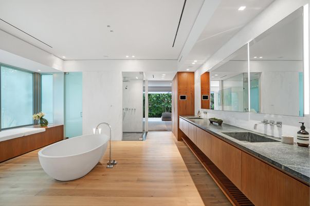 Bathroom, Dual Sink Vanities, Free Standing Baths, Glass Shower, Interior, Marble Walls, Recessed Lighting, Wood Texture Flooring
