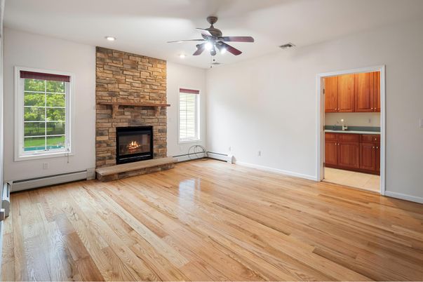 Empty room, Fireplace, Interior, Recessed Lighting, Stone Walls, Wood Texture Flooring