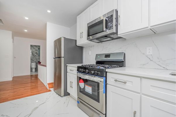 Interior, Kitchen, Marble, Marble Walls, Recessed Lighting, Stainless Steel Appliances, Wood Texture Flooring