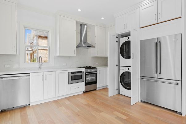 Interior, Kitchen, Marble Walls, Recessed Lighting, Stainless Steel Appliances, Washer, Wood Texture Flooring