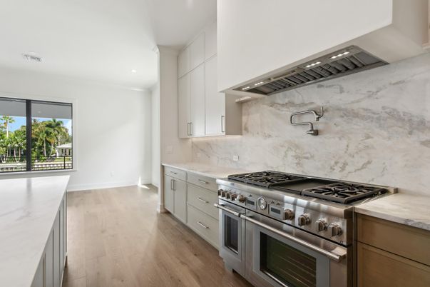 Interior, Kitchen, Marble Walls, Recessed Lighting, Stainless Steel Appliances, Wood Texture Flooring