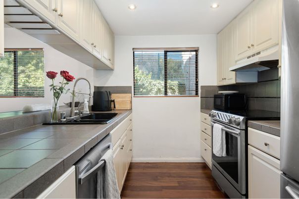 Interior, Kitchen, Recessed Lighting, Stainless Steel Appliances, Tile Countertops, Wood Texture Flooring