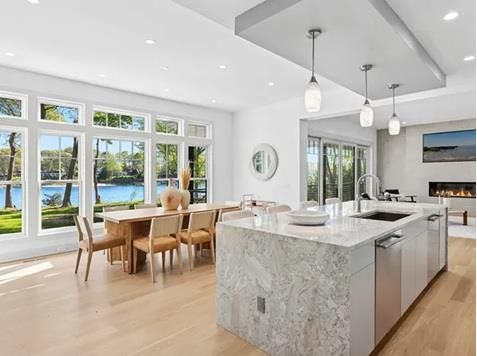Dining room, Fireplace, Interior, Kitchen, Pendant Lights, Recessed Lighting, Stainless Steel Appliances, Water, Wood Texture Flooring